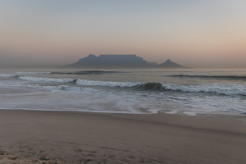 A blurry photo of a beach with waves coming in